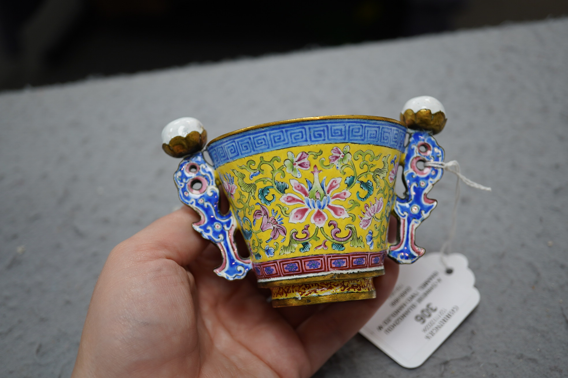 A Chinese Guangzhou enamel two handled wine cup, four character Qianlong mark and of the period (1736-1795)